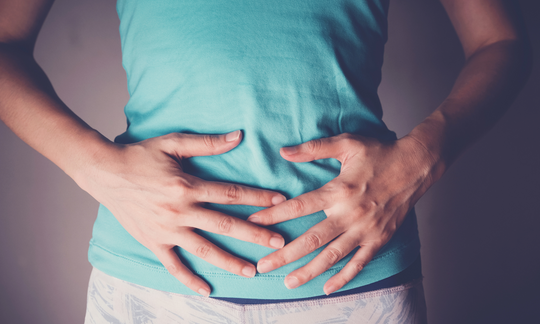 Woman in pain as a result of gut health problems